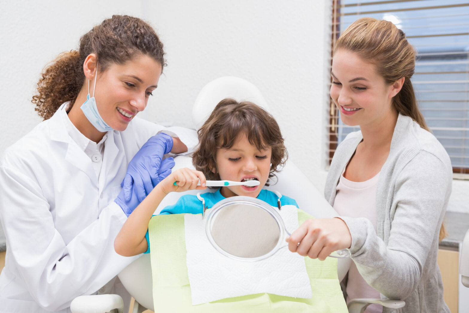 Parent and child consulting a pediatric dentist in Huntingburg IN about children's oral health